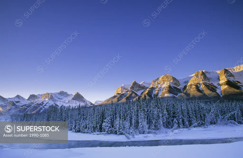 Winter sunrise on the Bow River in the Canadian Rockies, Alberta, Canada