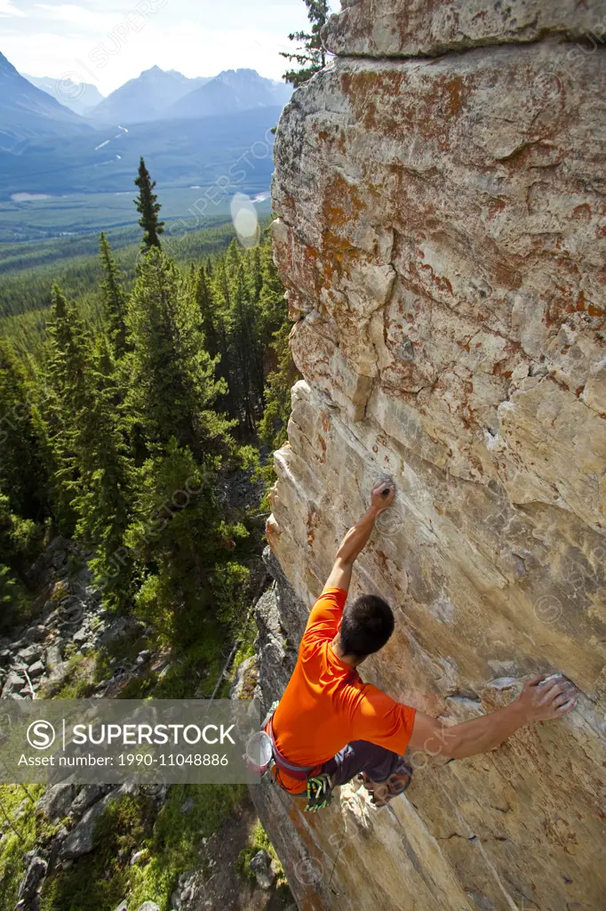 A strong male climber climbing, RUDED2 10d, Silver City, Castle Mtn, Banff, AB