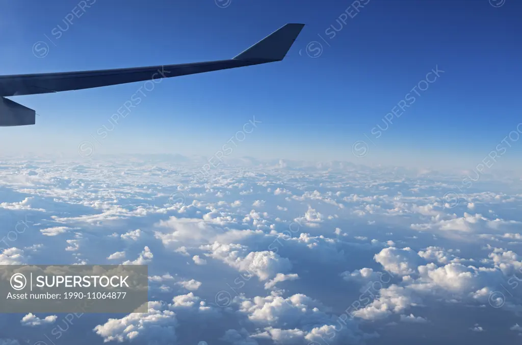 Aerial, clouds, flying, new moon, airplane wing in flight,