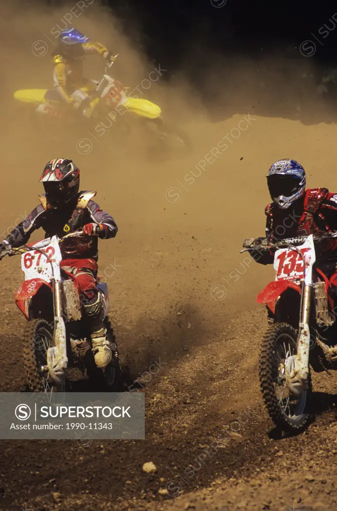 Two Motocross riders racing for the lead, Nanaimo Wastelands, Vancouver Island, British Columbia, Canada.
