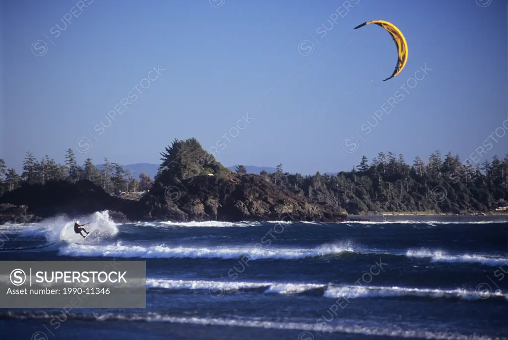 Kite boarder with yellow sail on Chesterman´s Beach, Tofino, Vancouver Island, British Columbia, Canada.