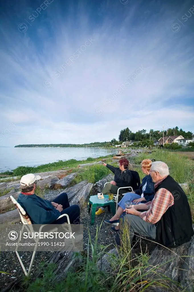 Campers enjoying a drink and each others company, Qualicum Beach, Vancouver Island, British Columbia, Canada.