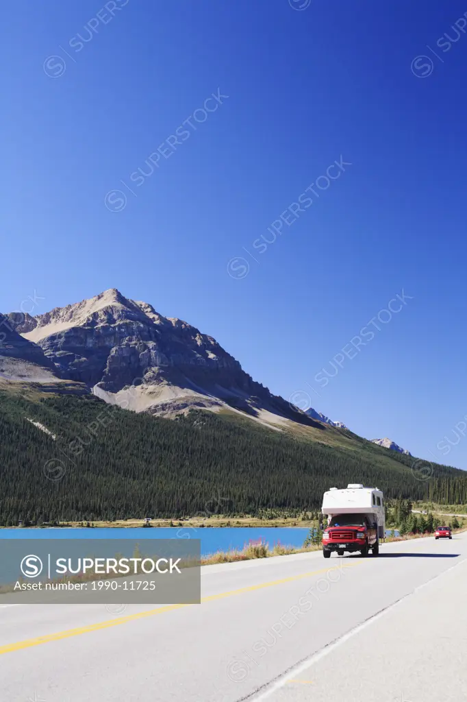 Camper and other traffic along the Icefields Parkway, Highway 93 North, near Bow Lake in Banff National Park, Alberta, Canada, part of the UNESCO Rock...