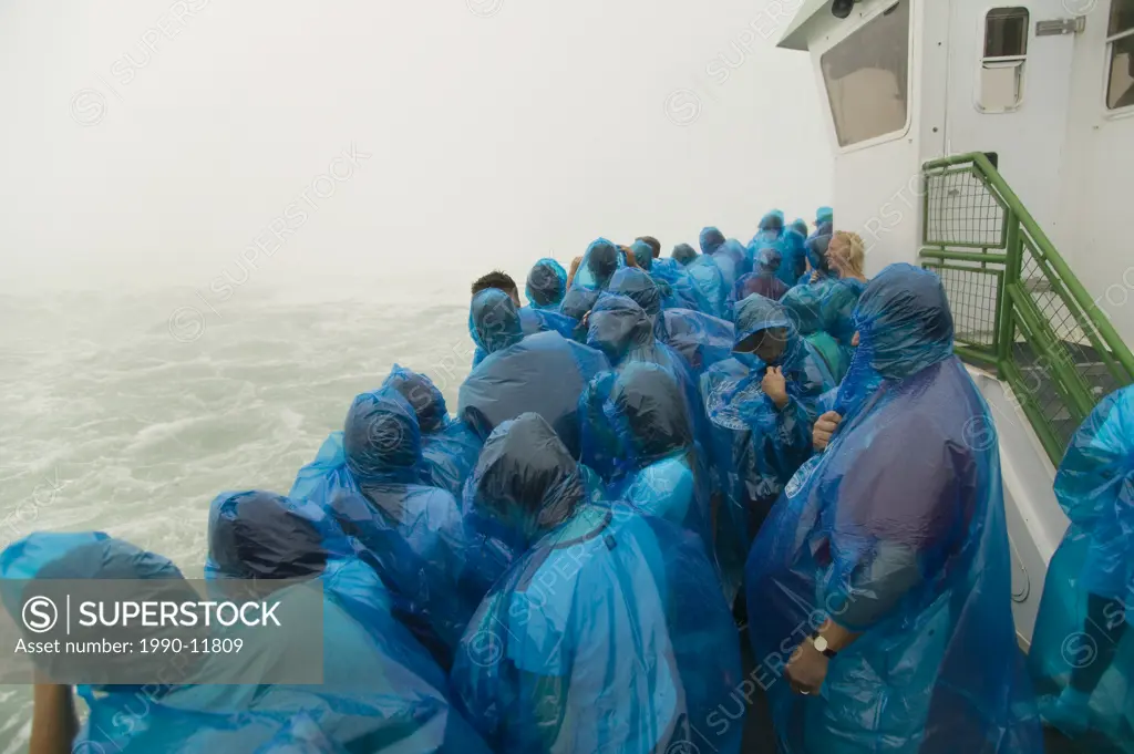 niagara falls ontario. blue raincoat clad tourists aboard the Maid of the Mist boats heading to the falls, Niagara Falls, Ontario, Canada