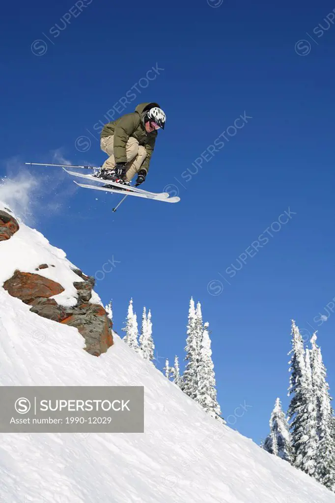 Male skier jumping boulders at Silver Star Mountain Resort, Vernon, British Columbia, Canada.