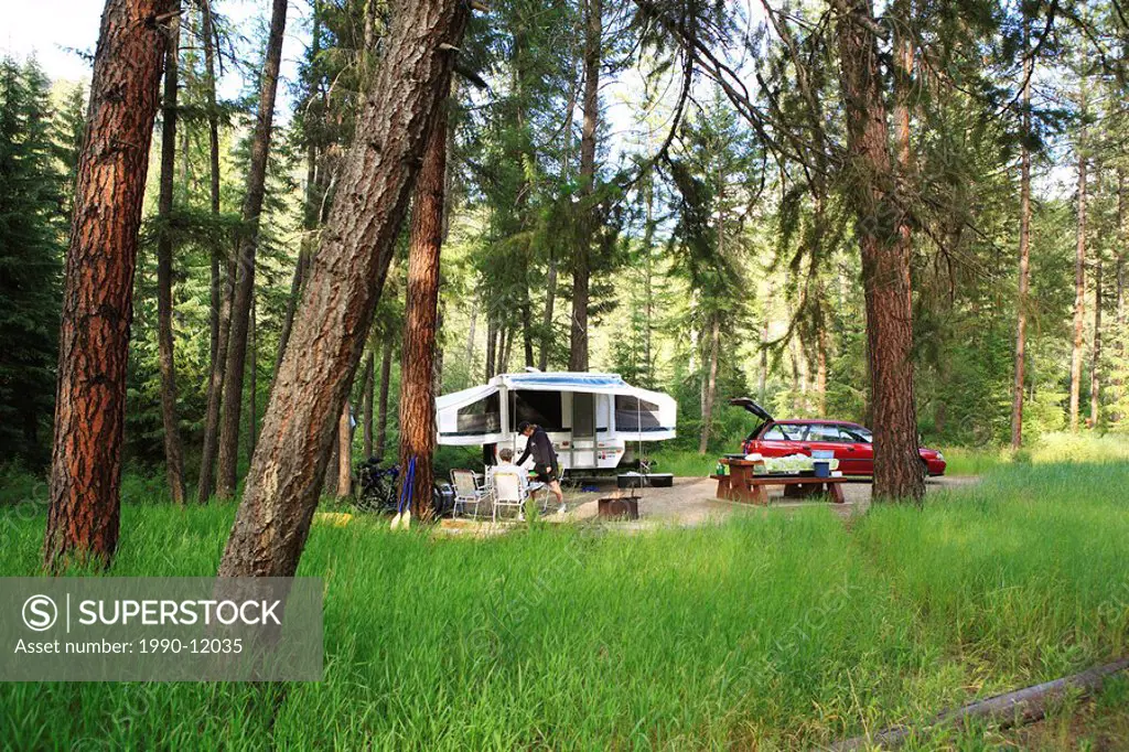 Campsite with tent trailer and car in Kettle River Provincial Park, Rock Creek, British Columbia, Canada.
