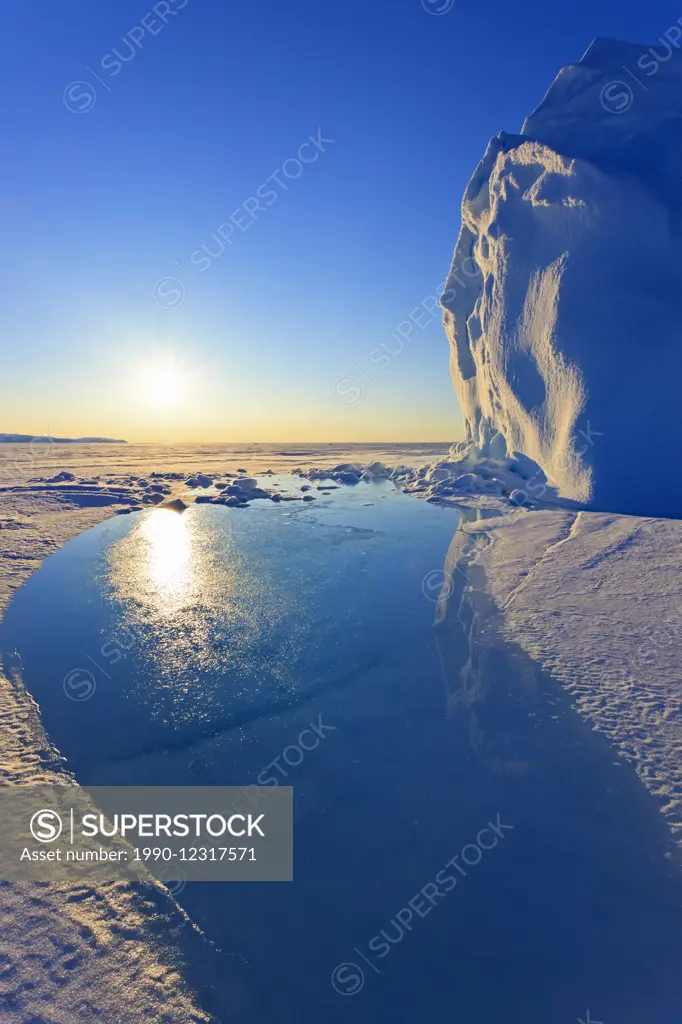 Midnight sun shining on an iceberg in Baffin Bay on the Arctic Ocean, north of Baffin Island, Nunavut, Canada in the Canadian Arctic