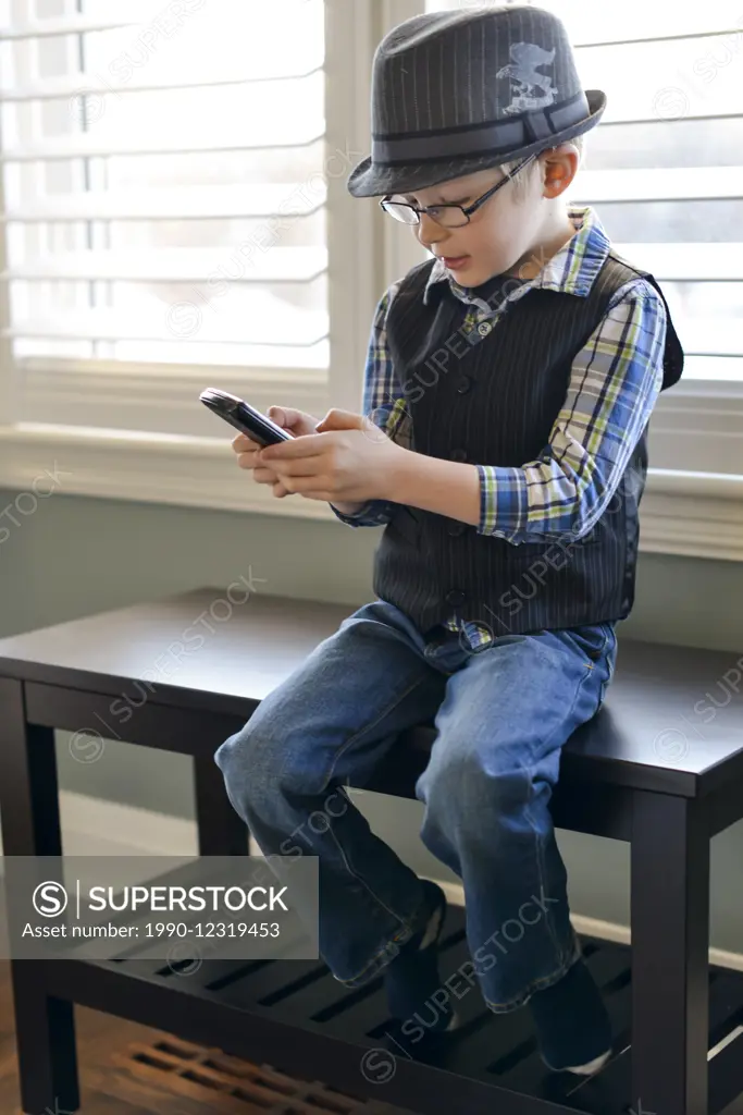 Young boy playing games on a cellphone