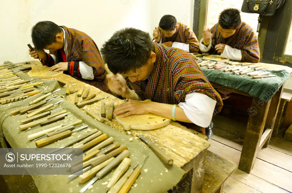 Male students practise wood carving in a Bhutanese school
