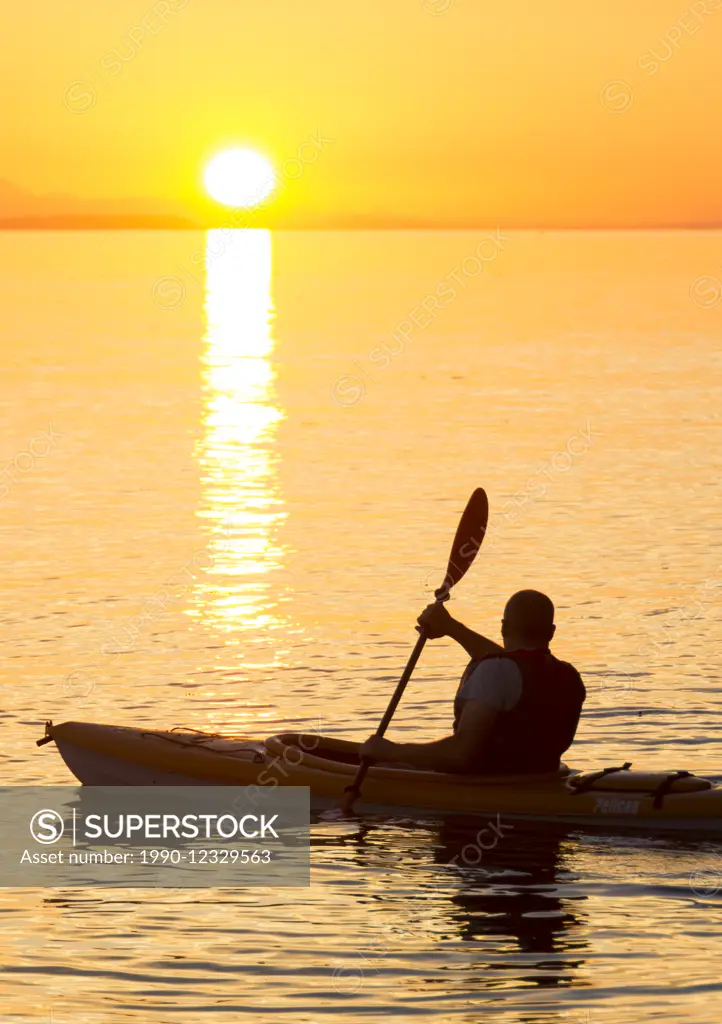 Kayaker in sunset, Powell River, British Columbia, Canada