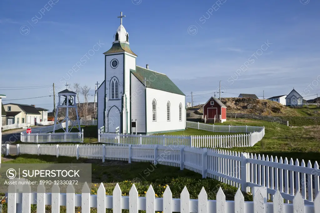 Holy Trinity Roman Catholic Church surrounded on all sides by white picket fences. Trinity, Newfoundland
