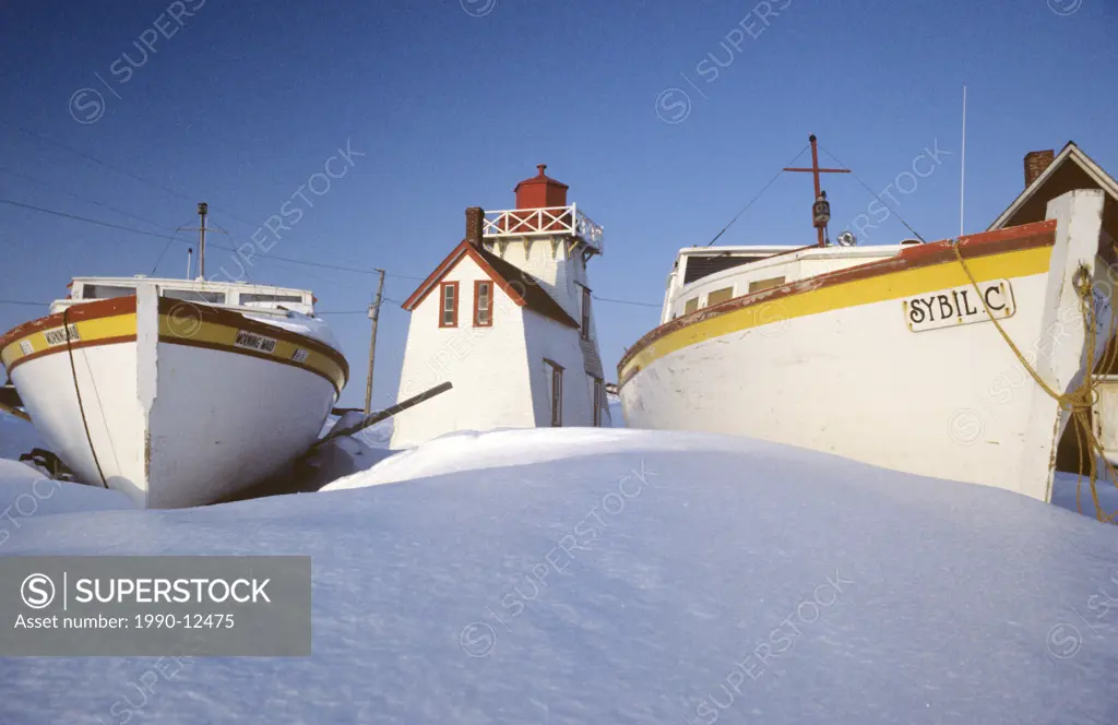 Fishing boats and Lighthouse in winter, North Rustico, Prince Edward Island, Canada