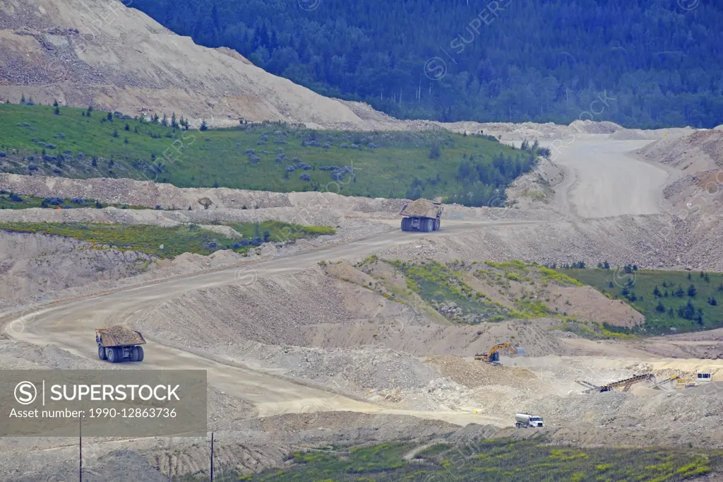Haul trucks taking waste material to dump site, Highland Valley copper mine, Logan Lake, British Columbia