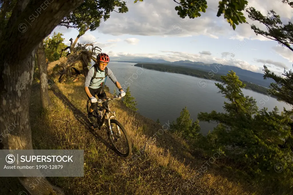 A young woman biking the amazing trails of Hornby Island, British Columbia, Canada.