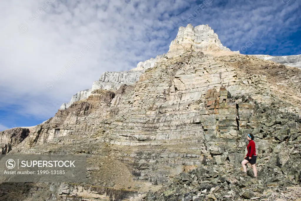 A female hiker looks out from Sentinel Pass near Moraine Lake in Banff National Park, Alberta, Canada.