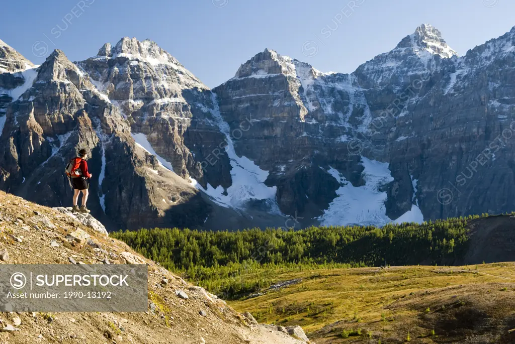 A female hiker above Moraine Lake and the Valley of the Ten Peaks en route to Sentinel Pass, Alberta, Canada.