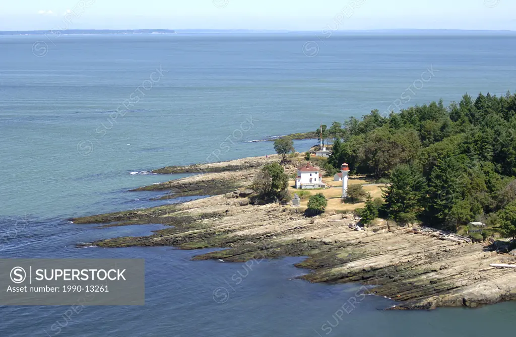 The Georgina Point Lighthouse at the entrance to Active Pass, Mayne Island, BC. Aerial photography of the Southern Gulf Islands. British Columbia, Can...