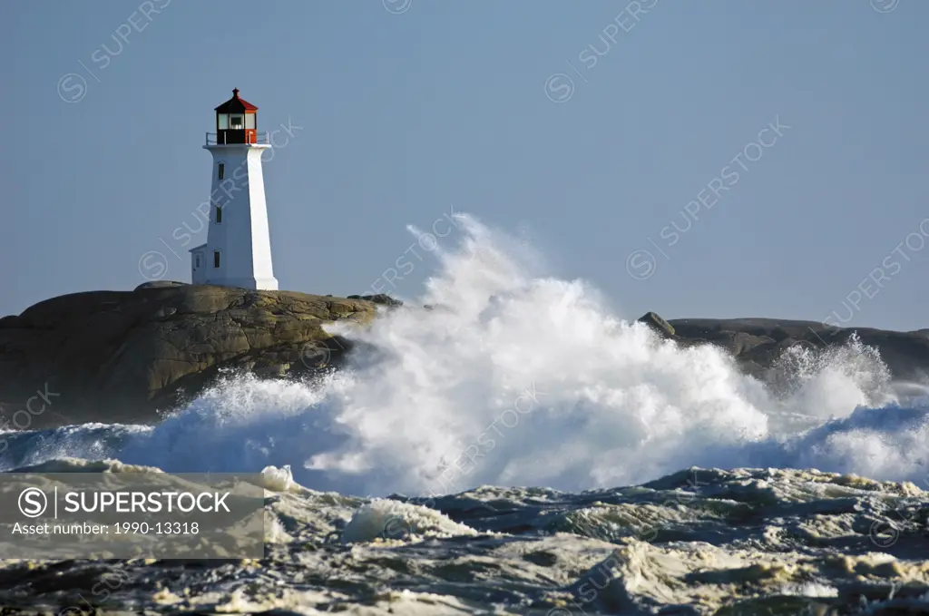 North Atlantic Ocean storm waves crash into granite coastline at Peggy´s Cove Lighthouse, Nova Scotia, Canada.