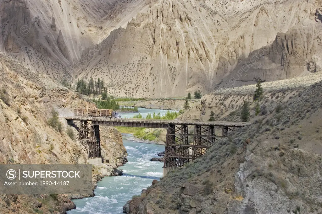 Logging truck crosses the Chilcotin River at Farwell Canyon, British Columbia, Canada