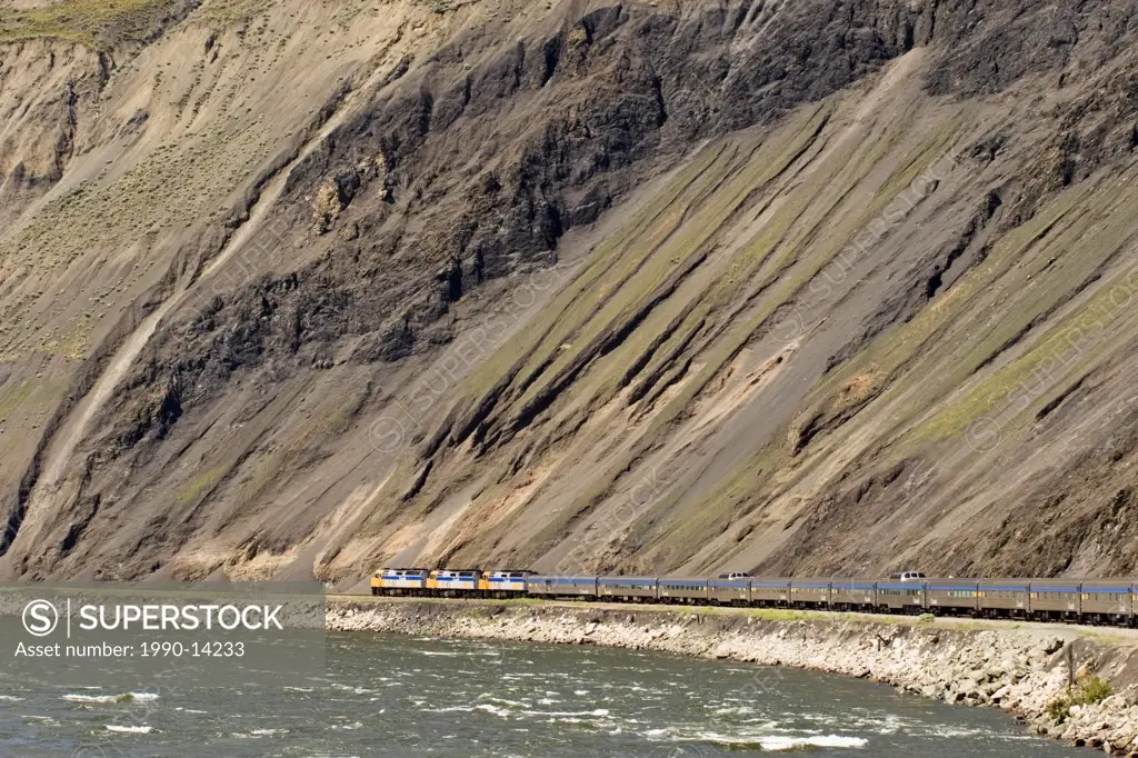 Passenger train going through Black Canyon along Thompson River near town of Ashcroft in British Columbia, Canada