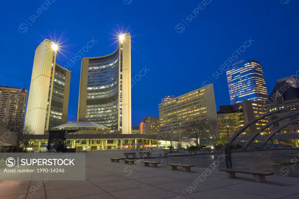 City Hall building and the Nathan Phillips Square at dusk in downtown Toronto, Ontario, Canada