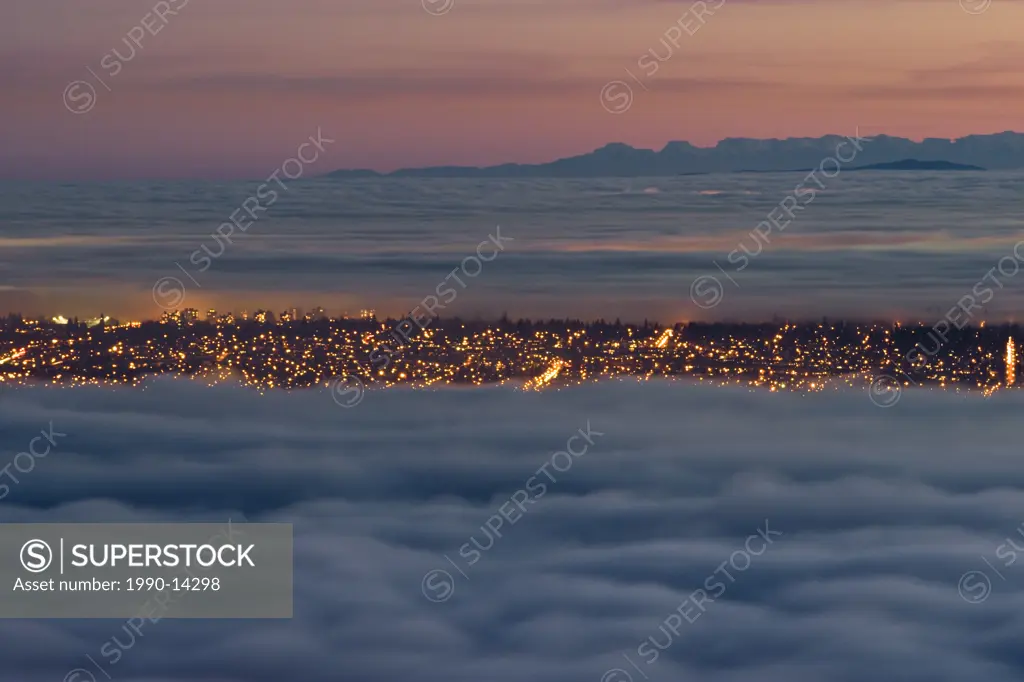 Vancouver and Lower Mainland partly covered with fog and clouds at sunset. View from Cypress Provincial Park in West Vancouver, British Columbia, Cana...