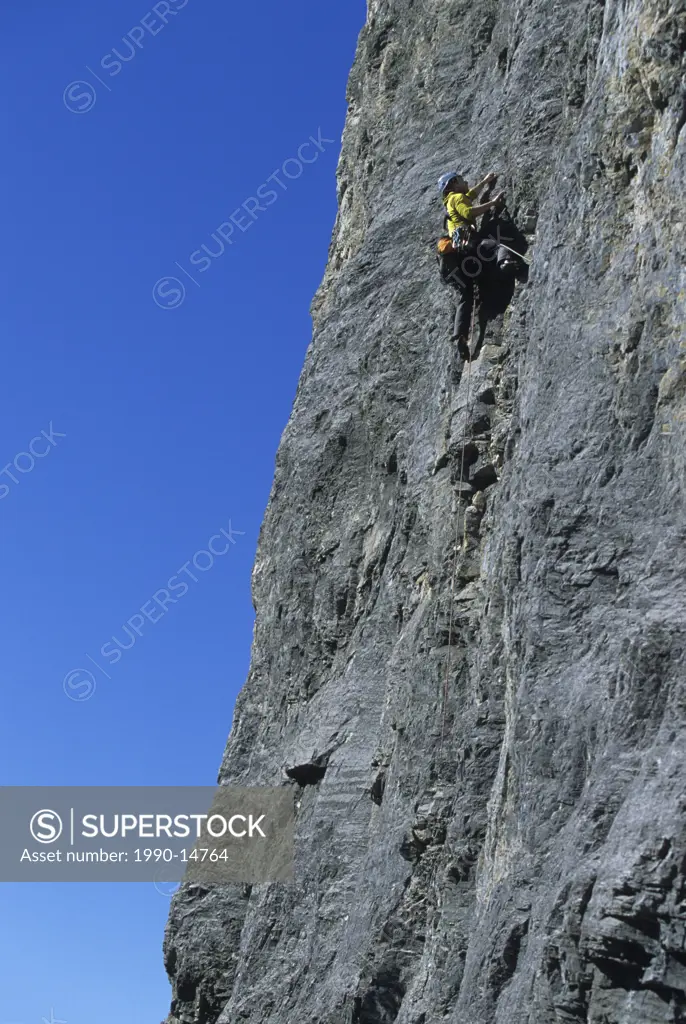 A climber on Jimmy and the Cruisers 10c, Mount Yamnuska, Kananaskis Country, Alberta, Canada