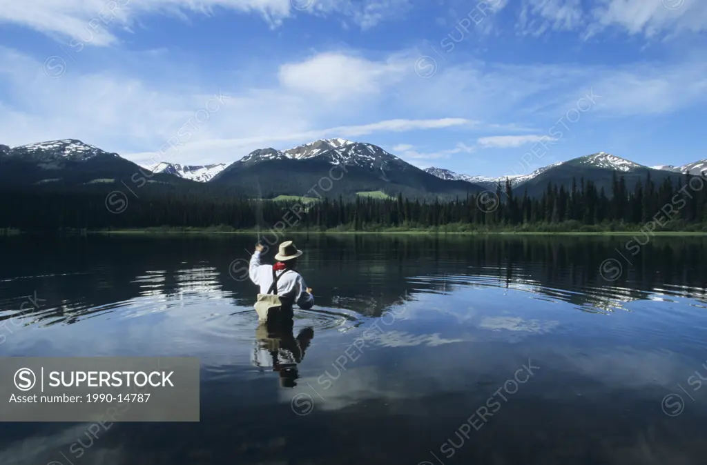 Fly fisherman on Dennis Lake, Bulkley Valley, British Columbia, Canada