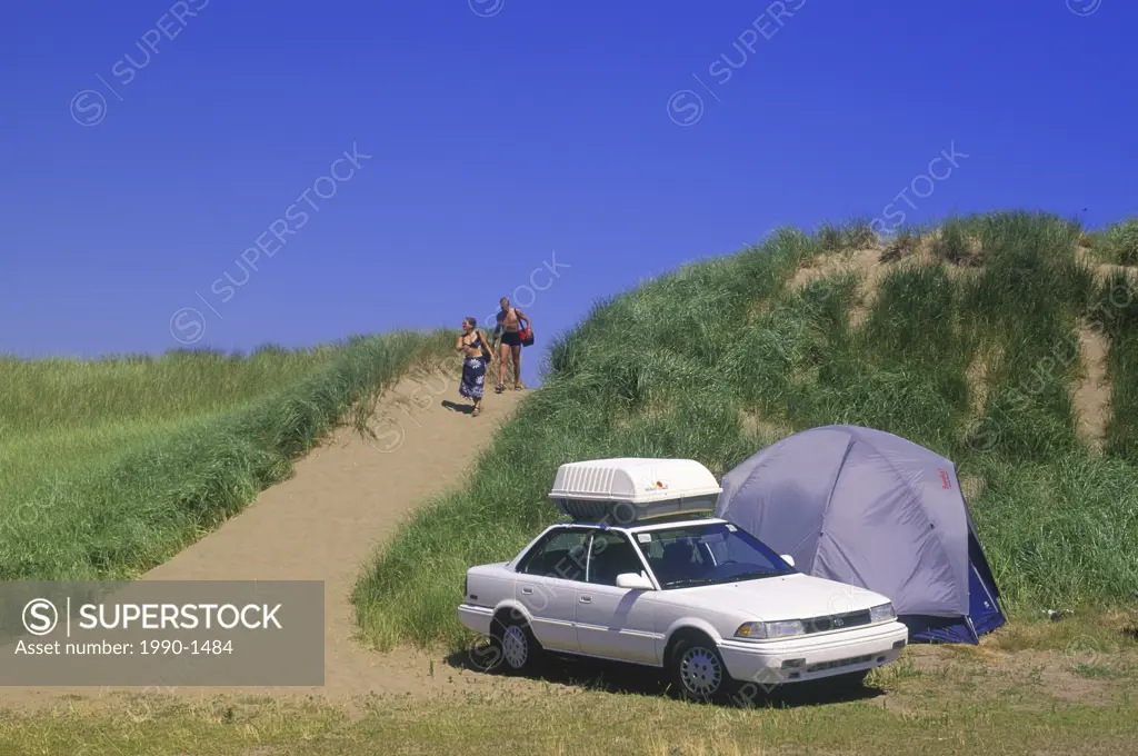 Couple camping on beach near Northumberland Strait at Shediac, New Brunswick, Canada