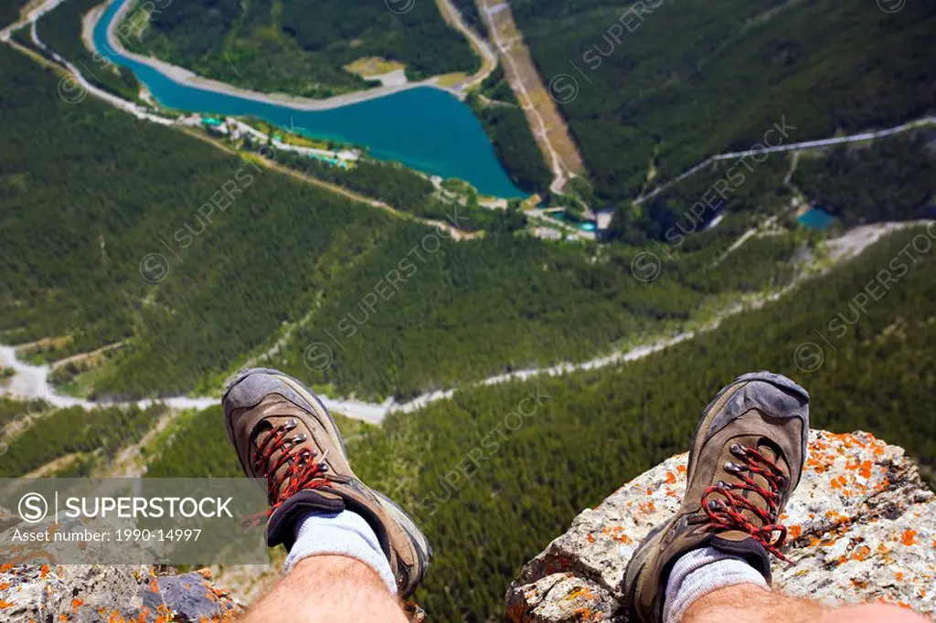 Hiker´s feet at edge of cliff, Mount Rundle near Canmore, Alberta, Canada