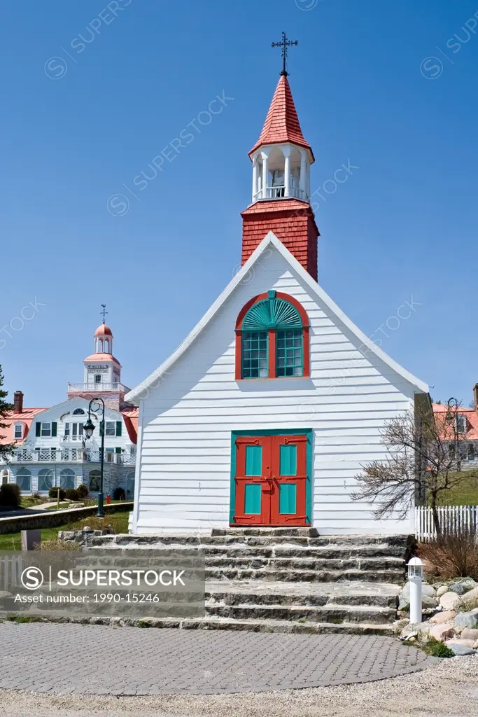 The ´´Little Chapel of Tadoussac´´ or The Indian Chapel´´ is the oldest wooden church in Canada, Tadoussac Hotel in the background, Tadoussac, Quebec,...