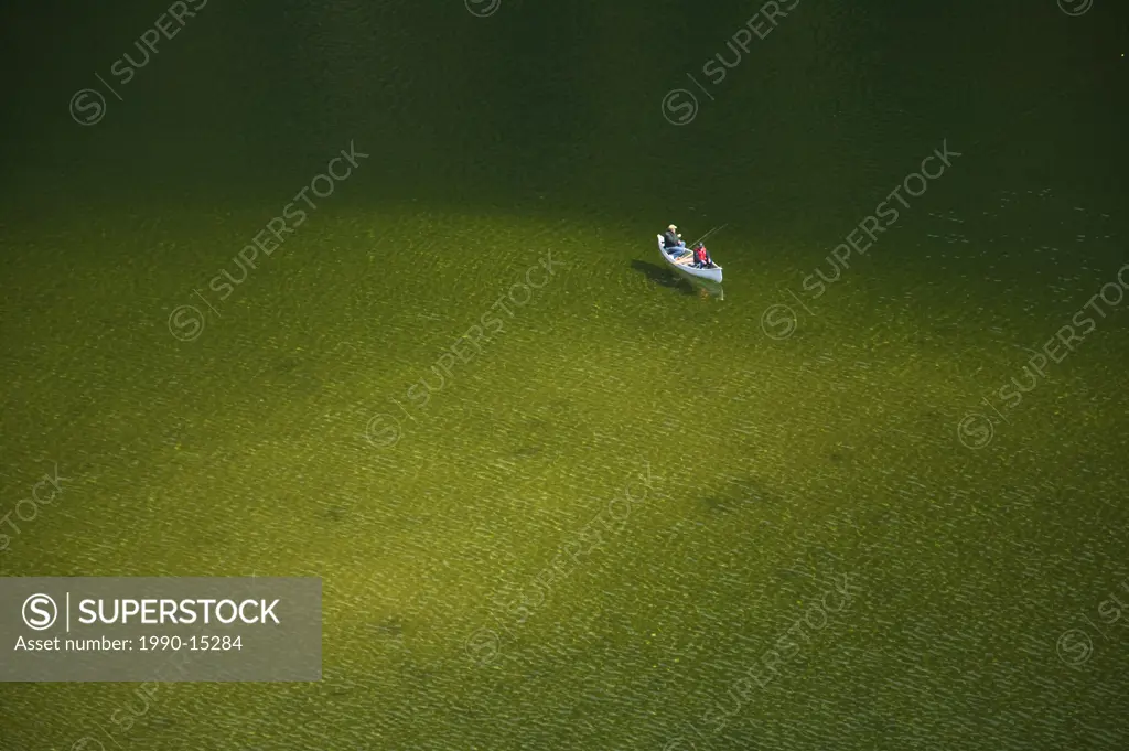 Canoeists float in green waters near Crest Creek a popular climbing area along the Gold River Hwy in Strathcona Provincial Park, Vancouver Island, Bri...