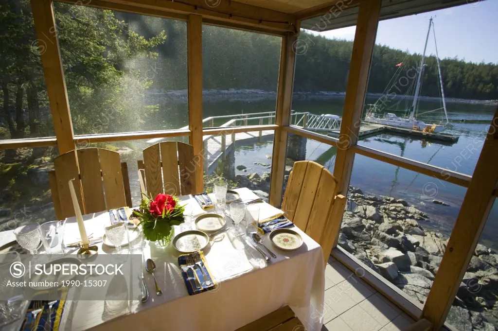 T´ai Li lodge on Cortes Island boasts intimate waterfront dining complete with a view of the sailboats, Cortes Island, British Columbia, Canada