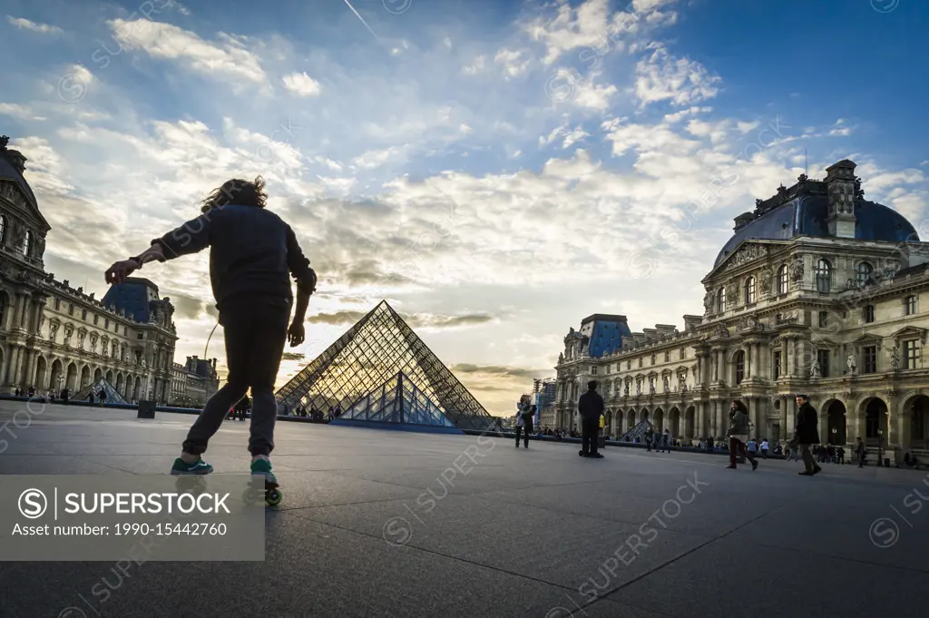 Roller skating practice at Louvre Pyramid at sunset