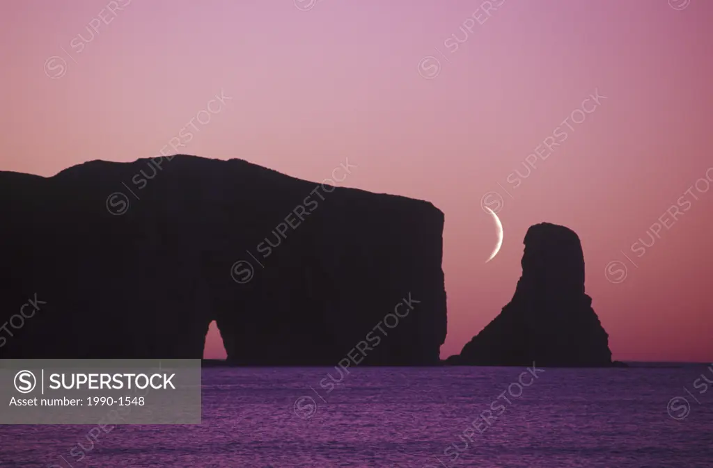 Perce Rock at dusk with crescent moon, Gaspe Peninsula, Quebec, Canada
