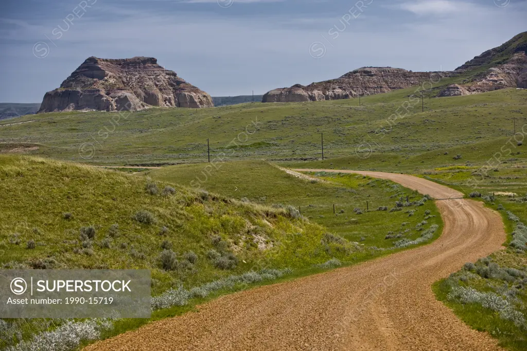Rural road and Castle Butte in the Big Muddy Badlands of southern Saskatchewan, Canada