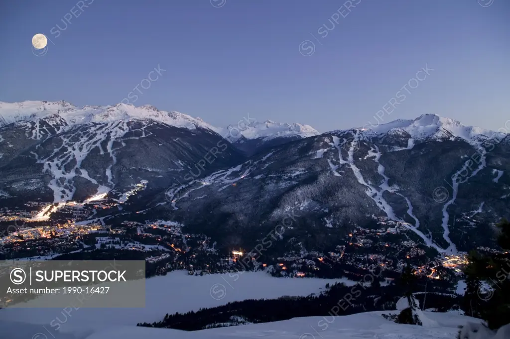 Whistler Village at dusk with Blackcomb Mountain and Whistler Mountain beyond, British Columbia, Canada