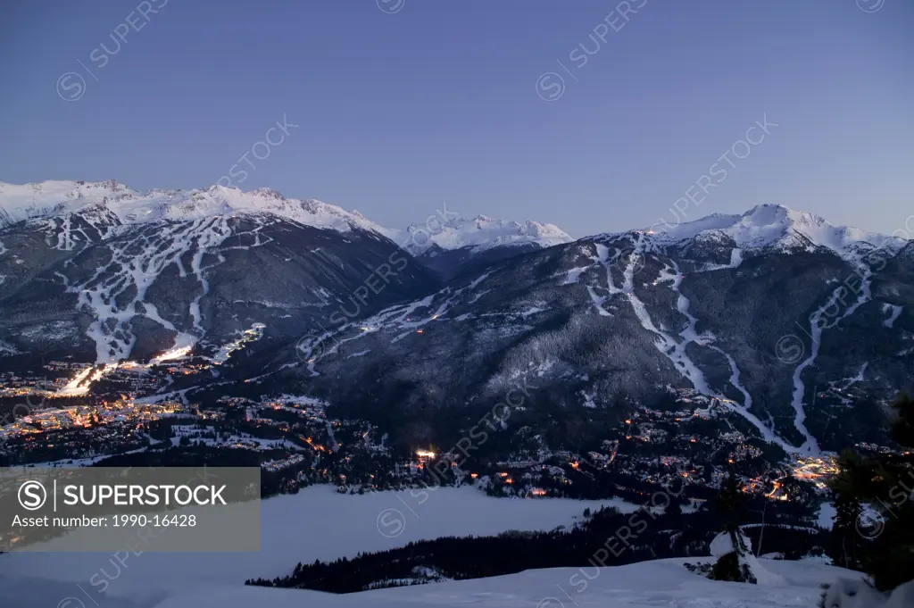 Whistler Village at dusk with Blackcomb Mountain and Whistler Mountain beyond, British Columbia, Canada
