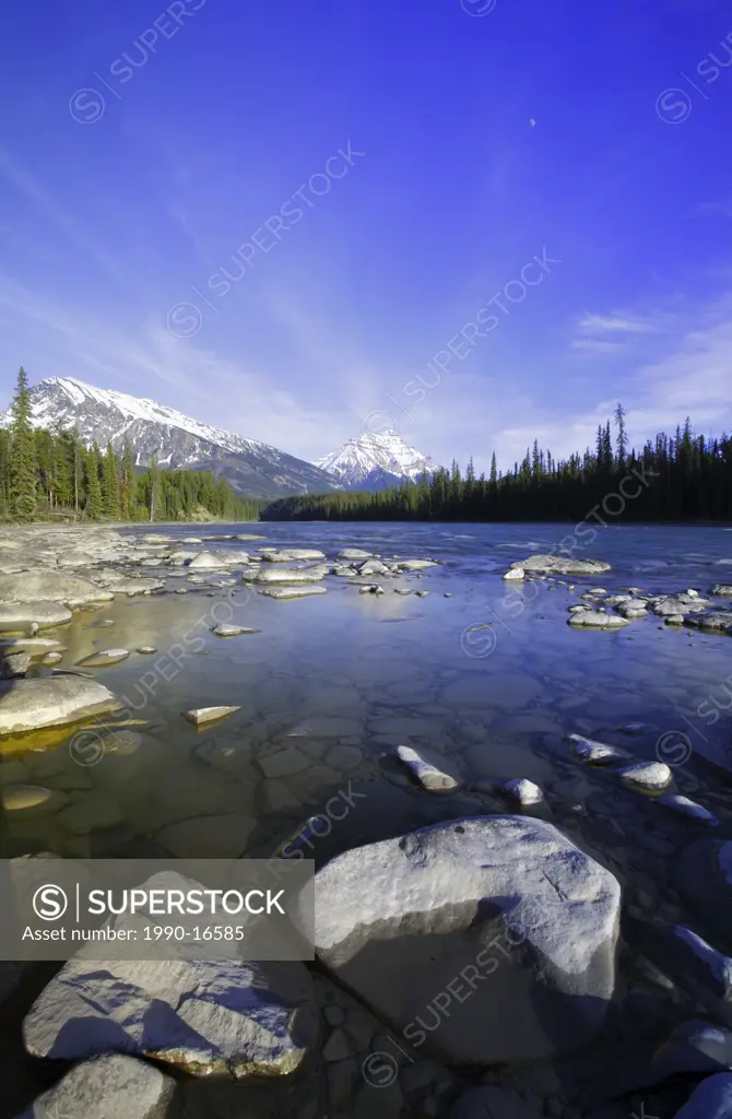 The Athabasca River in early spring with Mt Hardisty and Mt Kerkeslin in the background, Jasper National Park, Alberta, Canada