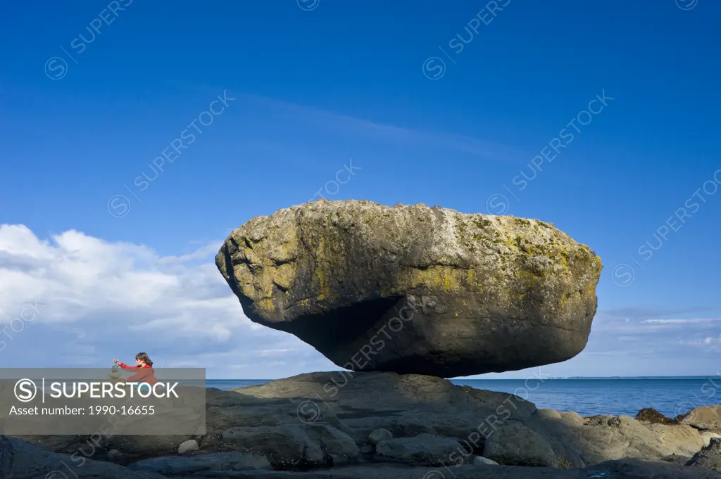 Child balancing rocks on beach, Balance Rock, Graham Island, Queen Charlotte Islands, British Columbia, Canada