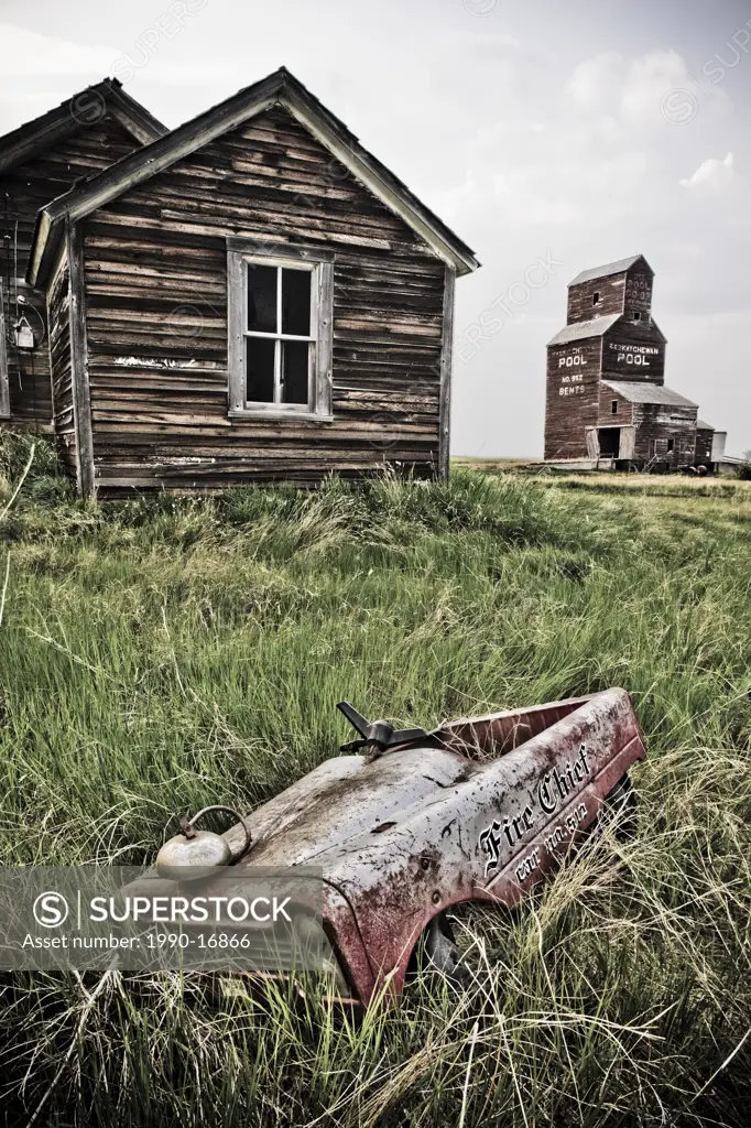Abandoned farm town with child´s pedal car, Bents, Saskatchewan, Canada