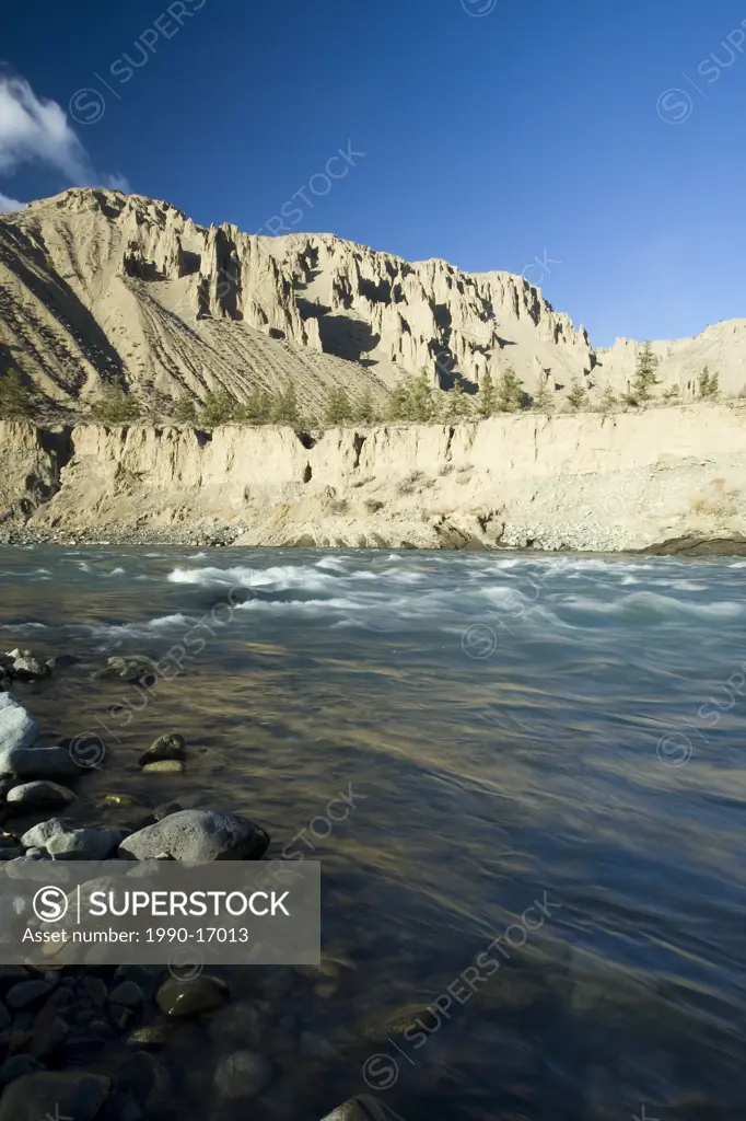 The Chilcotin River flows by sandstone cliffs as it nears the Fraser River, Chilcotin Plateau, British Columbia, Canada