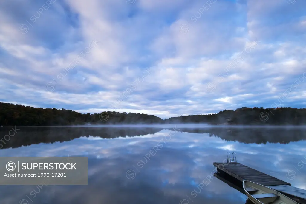 Clouds reflecting in Horseshoe Lake at daybeak in Ontario´s Muskoka Region