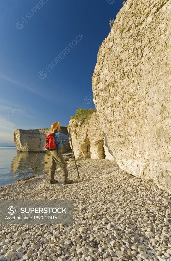 hiker along limestone cliffs, Steep Rock, along Lake Manitoba, Manitoba, Canada