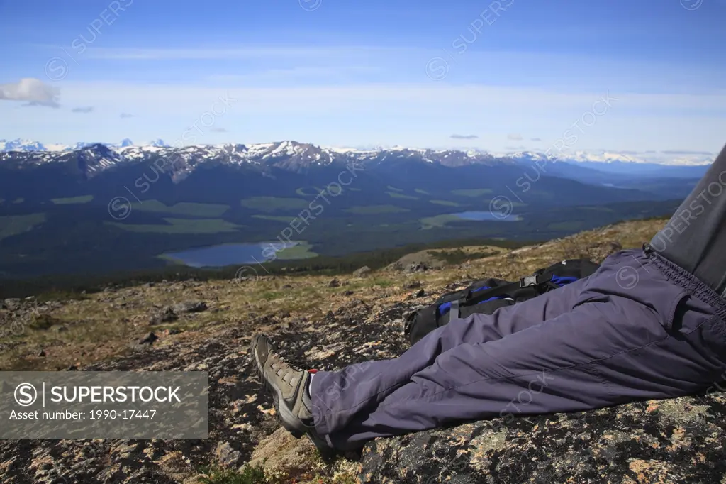 Hiker overlooking valley from Hudson Bay Mountain, Smithers, British Columbia