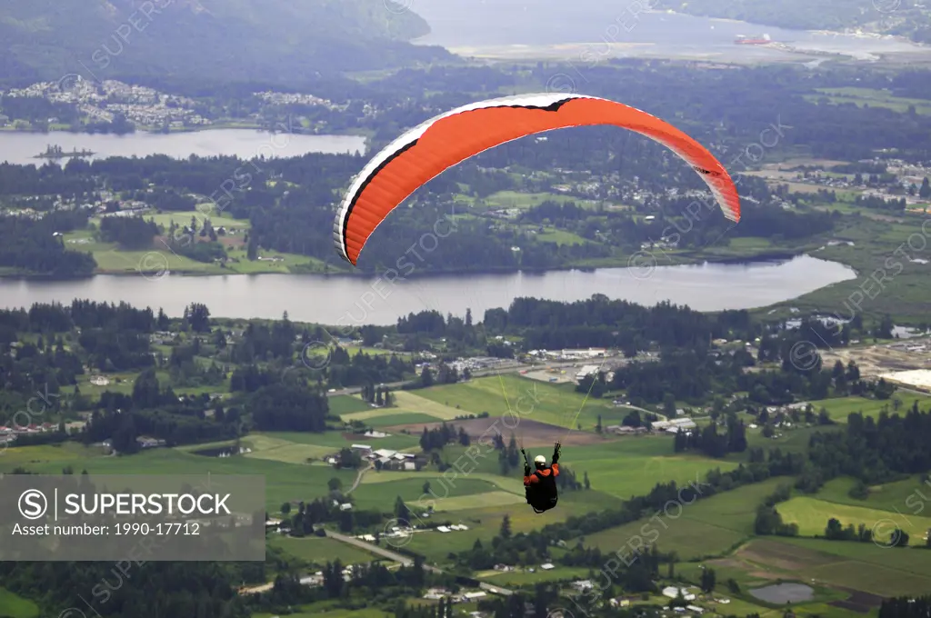 Paraglider sails from Mt. Prevost in Duncan, BC.