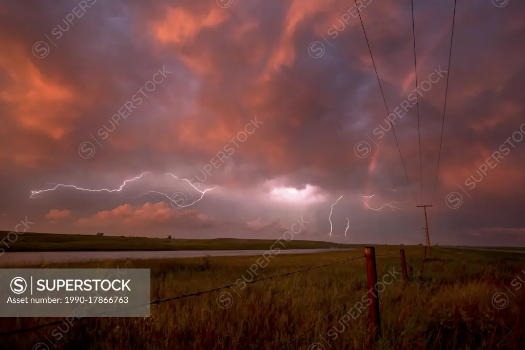 Storm with lightning flashing at sunset in rural Saskatchewan, Canada