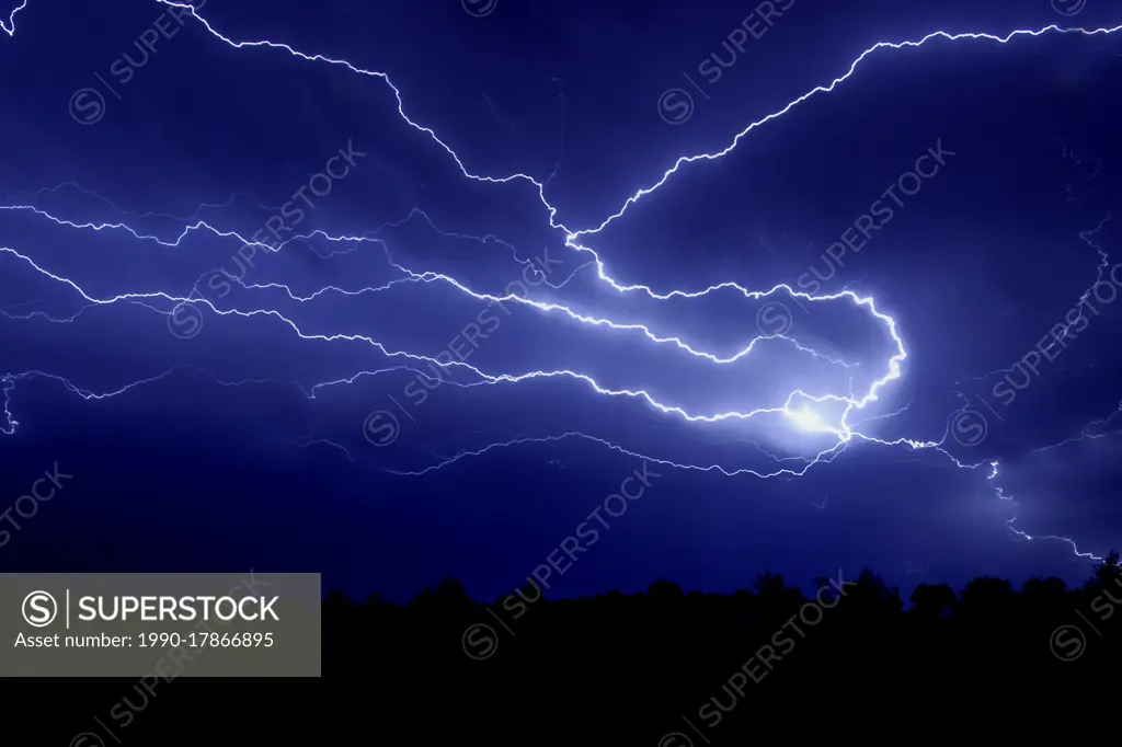 Storm with lightning overhead at night in rural Manitoba, Canada
