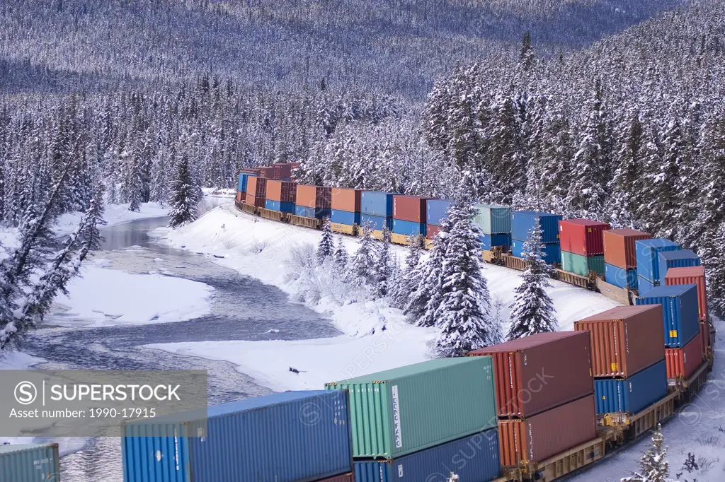 Container Train, Bow River and snow covered trees in winter. Banff National Park, Alberta.
