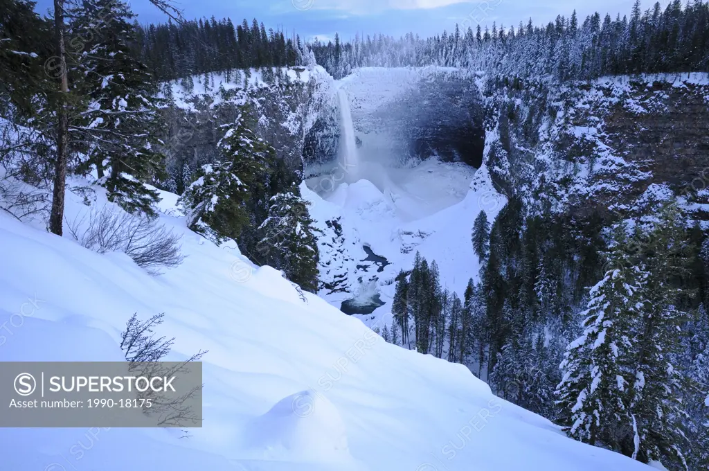 Helmcken Falls in winter with accumulated snow ice cone, Wells Gray Provincial Park, British Columbia, Canada